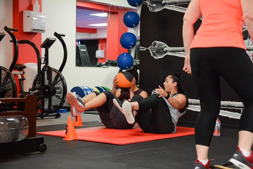 Partner floor work during a conditioning class