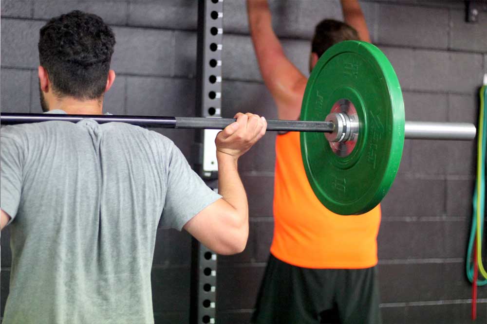 Barbell back squat with bumper plates in Functional Strength