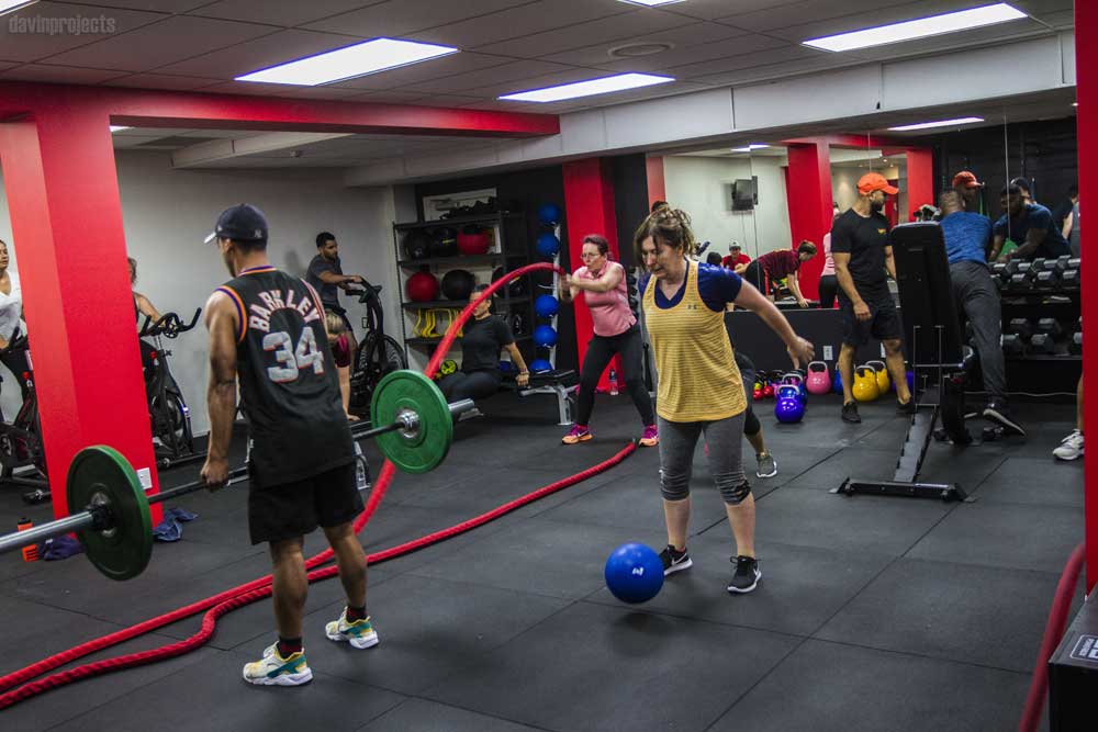 The Uplift gym floor mid-class, kettlebells and battle ropes out