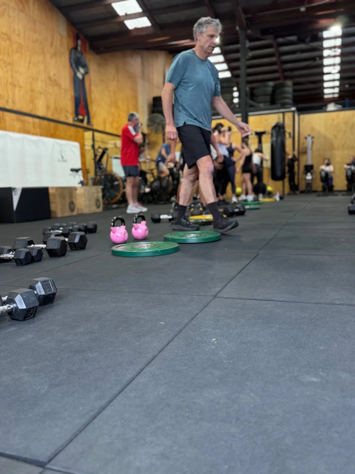 The Uplift gym floor mid-class, kettlebells and battle ropes out