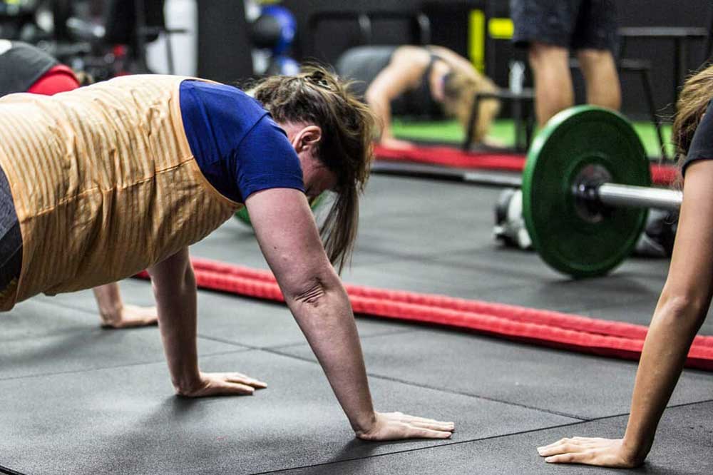 Members grinding through floor conditioning in Max Out
